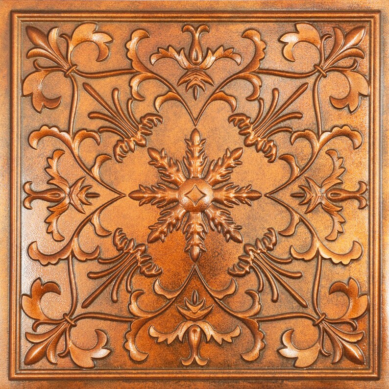 Pu&ograve; includere: Una piastrella decorativa con un designo intricato in rilievo di colore rame. Il design presenta un motivo centrale a fiocco di neve circondato da motivi floreali a spirale.