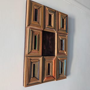 Recycled skateboard art piece on wood