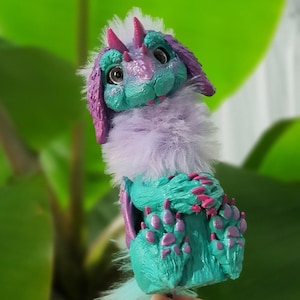 May include: A set of three ceramic mugs with a speckled, matte finish. The mugs are in shades of cream, light brown, and dark brown. Each mug has a simple, minimalist design, perfect for coffee or tea.