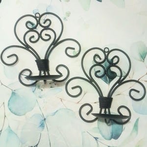 Pair black wrought iron wall mount candle holders