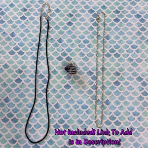 May include: Two necklaces, one black cord and one silver chain, are displayed on a blue and white patterned background.  The text "Not Included! Link To Add Is In Description!" is at the bottom of the image.
