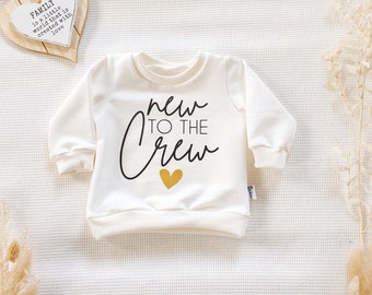 Cremeweiss (Weiss) - New to the Crew - mit Herz (Schwarz-Gold) - Sweater von Sharlene Babymode Handmade in Germany Baby Pullover, Sweatshirt