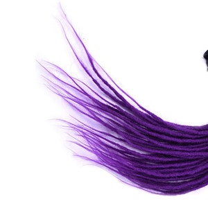 May include: A bundle of black and purple dreadlocks. The dreadlocks are a gradient, transitioning from black to a vibrant purple. The image includes a purple square with the number 8 in white, and a close-up of the dreadlocks.