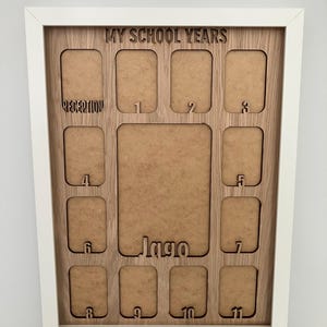 May include: A white-framed wooden photo collage board titled MY SCHOOL YEARS with cutouts for photos labeled RECEPTION, 1 through 11, and a larger central space featuring the name Jago in a cutout script font at the bottom center.