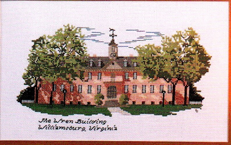 May include: A cross-stitch embroidery of the Wren Building at the College of William & Mary in Williamsburg, Virginia. The building is red brick with white trim and a clock tower. There are two green trees on either side of the building.
