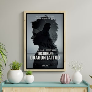 May include: Movie poster for the film "The Girl with the Dragon Tattoo" featuring Daniel Craig and Rooney Mara. The poster has a black and white color scheme and features a silhouette of a person with a mohawk.