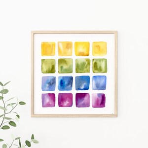 K&ouml;nnte beinhalten: Ein gerahmtes Aquarellbild mit einem Raster aus 16 Quadraten. Die Quadrate sind in Gelb-, Gr&uuml;n-, Blau- und Violettt&ouml;nen bemalt.
