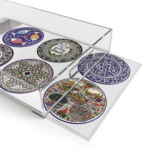 May include: Clear acrylic serving tray with decorative circular designs. The tray features various colorful patterns, including floral, fish, and landscape motifs. Some designs include text. The tray is ideal for serving or displaying items.