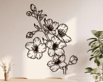 May include: Black and white line art wall decor featuring a stylized floral design with cherry blossoms. The design is reminiscent of a branch with several flowers and buds.