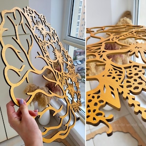 May include: A circular wooden wall art piece featuring an intricate laser-cut design of a brain silhouette integrated with floral and botanical patterns. The natural wood finish displays a warm golden-brown tone with detailed cutouts.