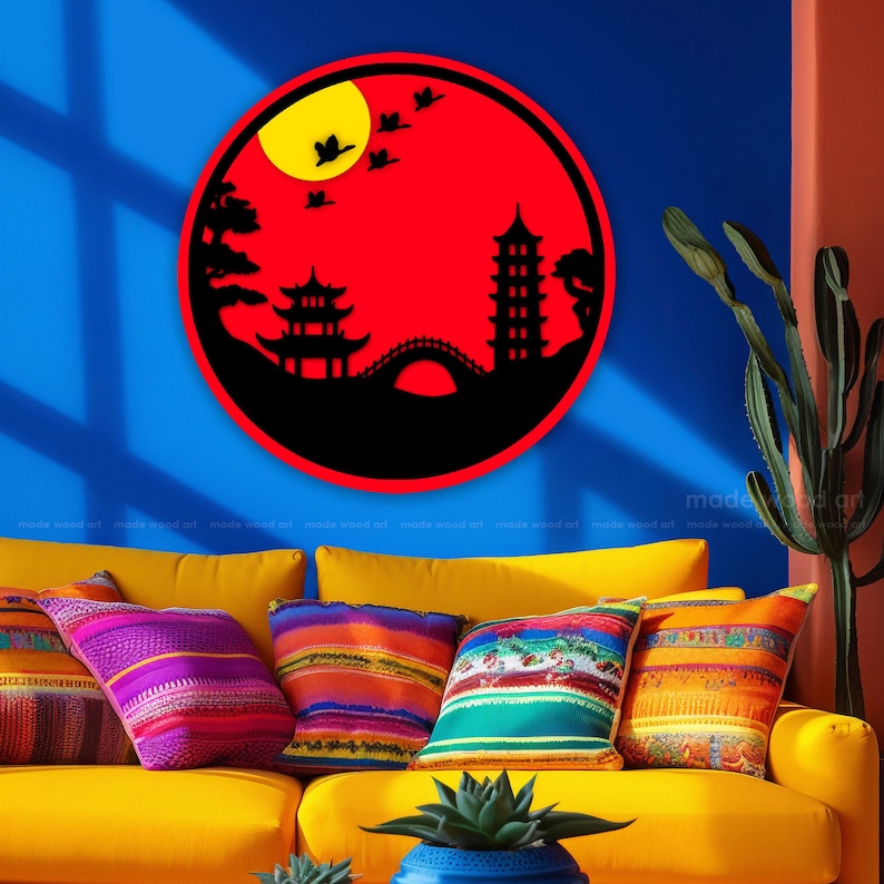 May include: A red and black circular wall decor with a silhouette of a pagoda, bridge, and trees. The background is a red circle with a yellow sun and black birds.