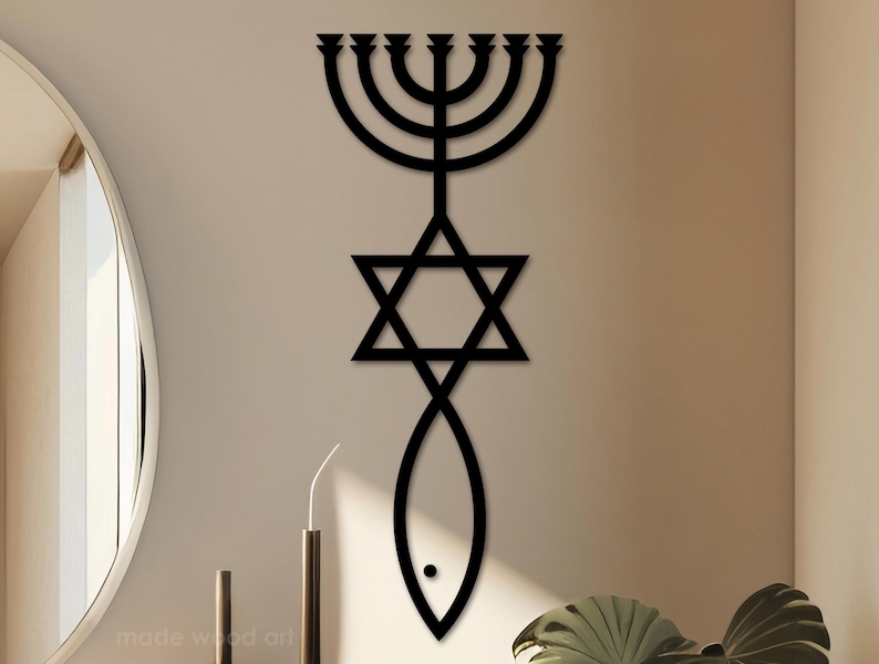 May include: Black wooden wall art featuring a menorah, Star of David, and fish symbol. The artwork is mounted on a neutral-colored wall, with a minimalist design. The piece is a decorative item for home decor.