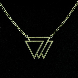 May include: A gold-toned necklace with a geometric pendant featuring two overlapping triangles.
