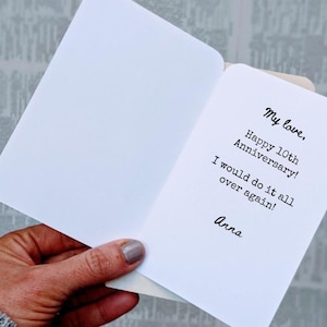 May include: A white card with a handwritten message that reads "My love, Happy 10th Anniversary! I would do it all over again! Anna."