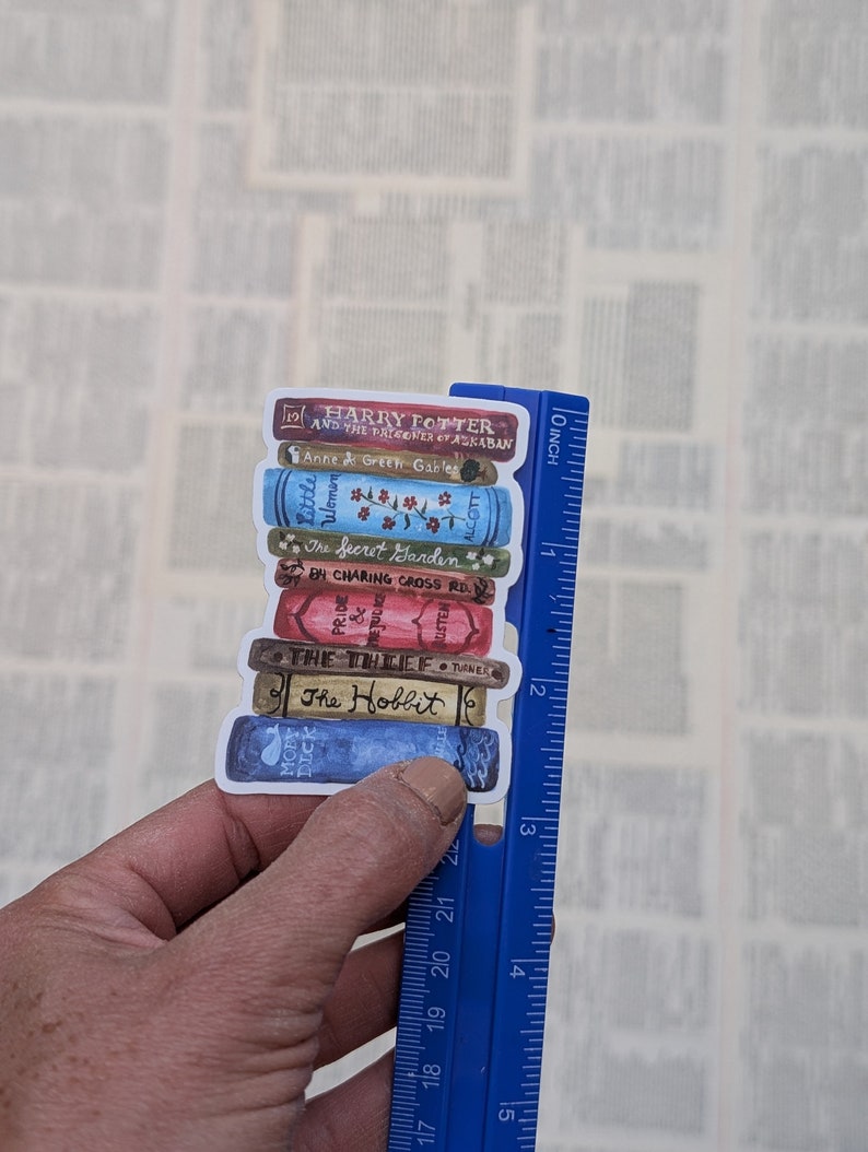 May include: A stack of book stickers featuring popular titles like "Harry Potter and the Prisoner of Azkaban", "Anne of Green Gables", "Little Women", "The Secret Garden", "Pride and Prejudice", "The Thief", and "The Hobbit". The stickers are arranged in a stack and are approximately 3 inches tall.