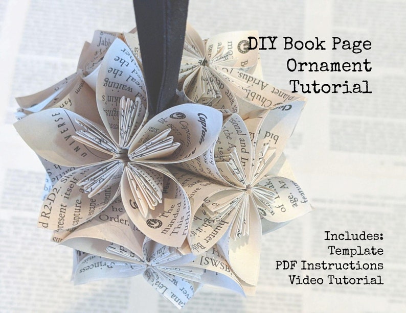 May include: A DIY book page ornament tutorial featuring a white paper ornament made from folded book pages. The ornament is shaped like a flower and is hanging from a black string. The text "DIY Book Page Ornament Tutorial" is written in black text on a white background.
