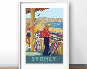 May include: Framed vintage travel poster for Sydney, Australia. The artwork depicts a beach scene with people, cars, and a view of the ocean. The poster features the word "SYDNEY" in large letters, with "BONDI BEACH AUSTRALIA" below.