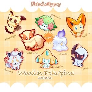 May include: A collection of eight illustrated wooden pins featuring cartoon characters Mimikyu, Shaymin, Victini, Arcanine, Litwick, Zoura, Jirachi, and Absol. The text reads NekoLollypop, New!, and Wooden Poke'pins 35mm on a light orange plaid background.