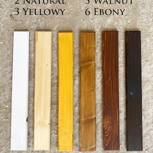 May include: Six wood samples in different shades of color, from white to black. The samples are labeled with numbers 1 through 6 and names: White, Natural, Yellowy, Hazelnut, Walnut, Ebony.