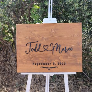 A romantic Personalized Couple Names Sign, featuring a heart design, perfect for celebrating love. This wooden name sign makes a unique wedding gift, Valentine's Day gift, or anniversary gift, adding a personal touch to any couple's home.
