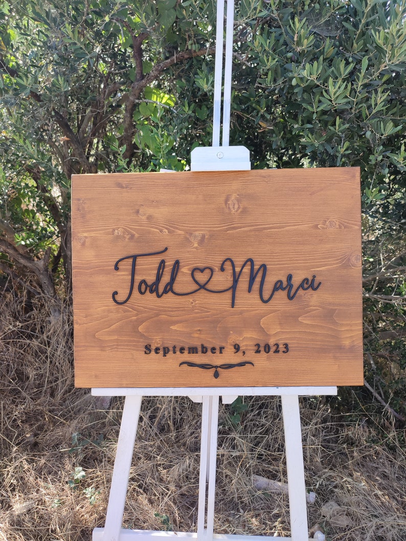 A romantic Personalized Couple Names Sign, featuring a heart design, perfect for celebrating love. This wooden name sign makes a unique wedding gift, Valentine's Day gift, or anniversary gift, adding a personal touch to any couple's home.