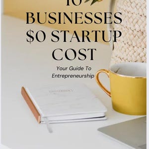 May include: A book titled "10 Businesses $0 Startup Cost" with the subtitle "Your Guide To Entrepreneurship" sits on a white surface. A yellow mug with a gold handle, a notebook, and a laptop are also present. White flowers are in a woven basket.