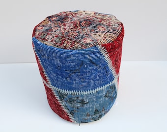 May include: A round, blue and red patchwork ottoman made from repurposed rugs. The ottoman is covered in a variety of patterns and colors, including blue, red, and white.