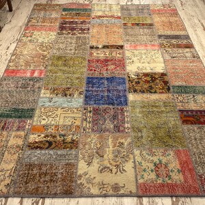 May include: A patchwork rug with a variety of colors and patterns, including red, blue, green, and brown. The rug is made up of many different pieces of fabric that have been sewn together.