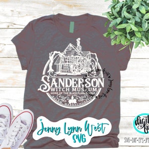 May include: A gray t-shirt with a white graphic of a house and the text "Sanderson Witch Museum, Home of the Black Flame Candle, Salem, Massachusetts". The text "Jenny Lynn West SVG" is also on the shirt.