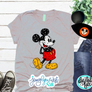 May include: A grey t-shirt featuring a distressed black and white image of Mickey Mouse wearing a red and black outfit. The text "Jennylynn West SVG" is at the bottom of the shirt.