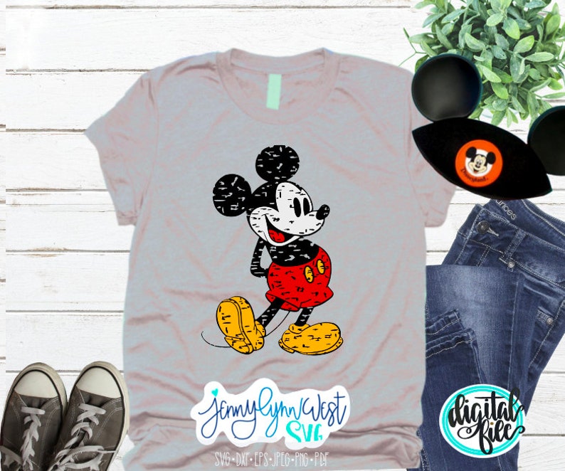 May include: A grey t-shirt featuring a distressed black and white image of Mickey Mouse wearing a red and black outfit. The text "Jennylynn West SVG" is at the bottom of the shirt.