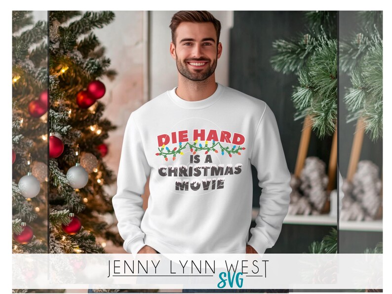 May include: White sweatshirt with a red, green, and blue graphic that says "Die Hard is a Christmas Movie" with Christmas lights around the text.