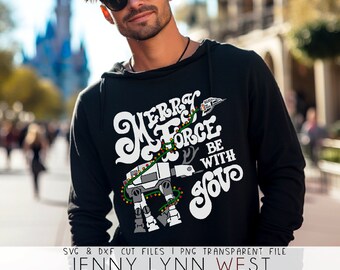 May include: A black hoodie with a white graphic design featuring a Star Wars AT-AT walker decorated with Christmas lights. The text reads "Merry Force Be With You".