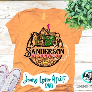 May include: A tan t-shirt with a black and white graphic of a house with a witch hat on top. The graphic is in a circle with the text "Sanderson Witch Museum" and "Home of the Black Flame Candle" inside. The text "Salem, Massachusetts" is at the bottom of the circle.
