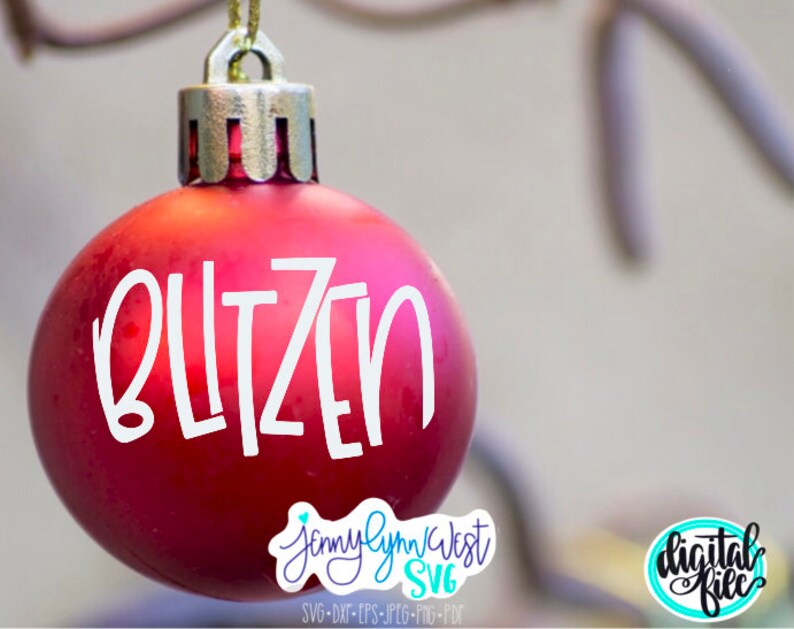 May include: A red Christmas ornament with the word "Blitzen" written in white on it. The ornament is hanging from a branch.