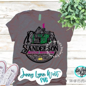 May include: A gray t-shirt with a black and green graphic of the Sanderson Witch Museum in Salem, Massachusetts. The graphic features a house with a witch's hat on top and the text "Sanderson Witch Museum" in a circle around it. The text "Home of the Black Flame Candle" is below the circle. The text "Jenny Lynn West SVG" is at the bottom of the shirt.