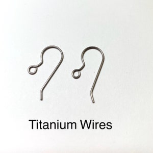 May include: Two silver titanium earring hooks. The hooks are made of titanium wire and have a simple, elegant design. Titanium Wires.