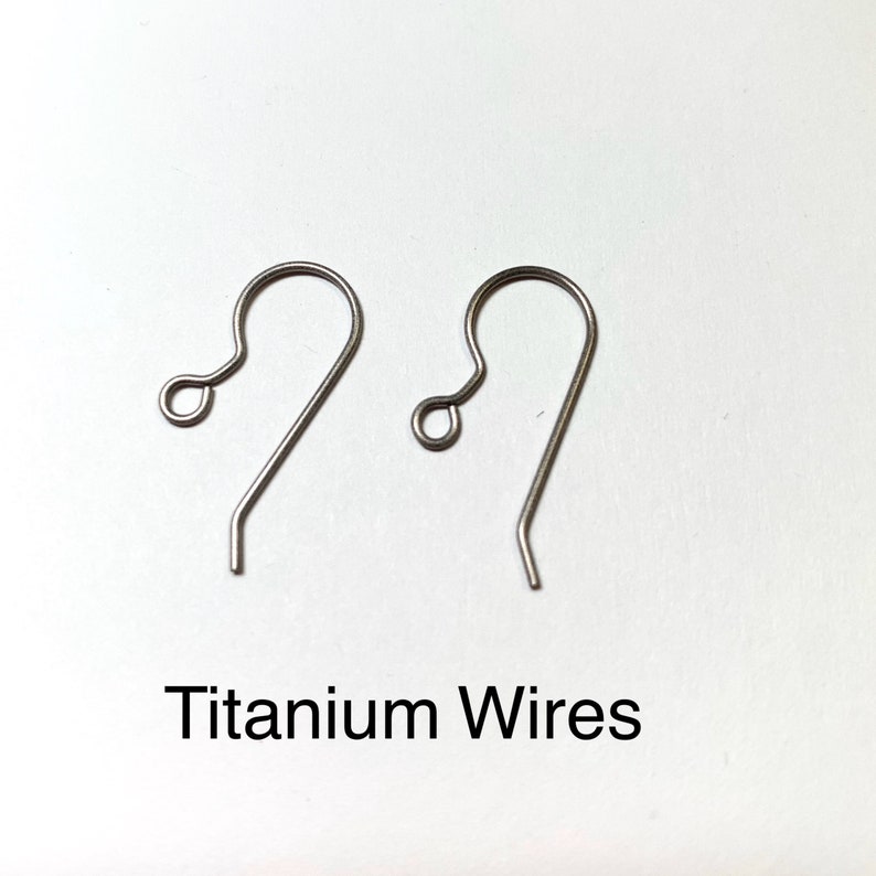 May include: Two silver titanium earring hooks. The hooks are made of titanium wire and have a simple, elegant design. Titanium Wires.