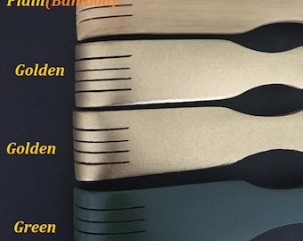 May include: Four back scratchers in different colors: plain bamboo, golden, golden, and green. The back scratchers have a rounded handle and a row of teeth.