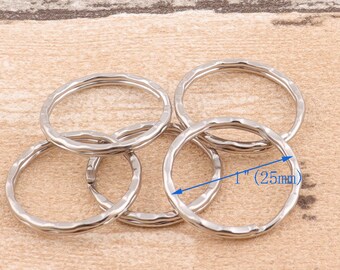 May include: Five silver key rings with a textured finish. The key rings are 1 inch (25 mm) in diameter.
