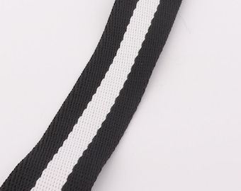 May include: Black and white striped webbing with a woven texture.