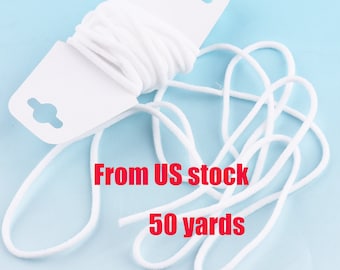 May include: A white elastic cord, 50 yards long, is wound around a white card with holes for hanging. The text "From US stock" and "50 yards" is printed in red on the image.