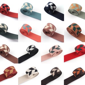 May include: Assortment of 12 different patterned woven ribbon trims. Each trim features a geometric pattern in various colors, including black, white, brown, green, and red.
