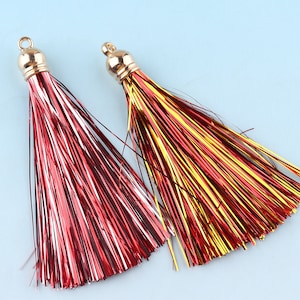 May include: Two gold tassel ornaments with red, white, and yellow metallic threads.
