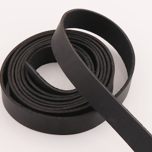 May include: A roll of black leather strap, coiled and ready for crafting projects.