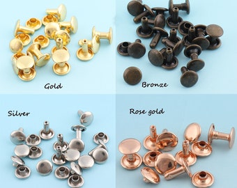 Puede incluir: Un surtido de remaches metálicos en oro, bronce, plata y oro rosa. Cada remache tiene una cabeza redondeada y un poste para asegurar los materiales. La imagen incluye los nombres de los colores: "Gold", "Bronze", "Silver" y "Rose gold".