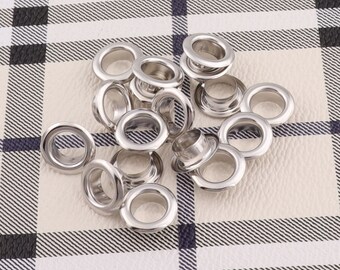 May include: A close-up of a pile of silver metal eyelets, commonly used for leather crafting projects.