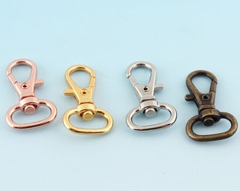 May include: Four metal keychains in different finishes: rose gold, gold, silver, and bronze. Each keychain has a simple, classic design with a swivel hook.