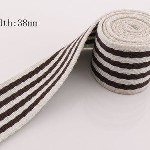 May include: Brown and white striped cotton webbing, 38mm wide.
