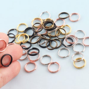 May include: Assortment of metal jump rings in various sizes and colors, including silver, gold, and bronze. The rings are ideal for jewelry making, crafting, and DIY projects.